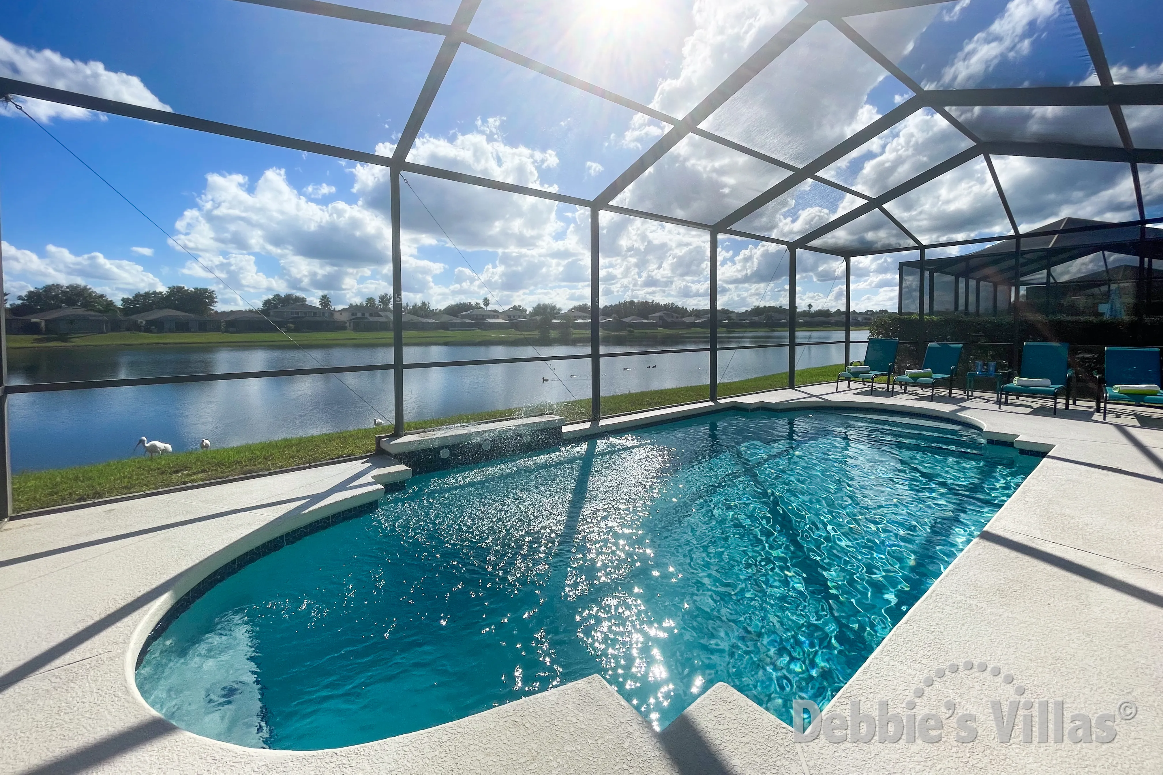 Gorgeous lake view for the sun drenched pool deck at this Sunset Lakes vacation villa