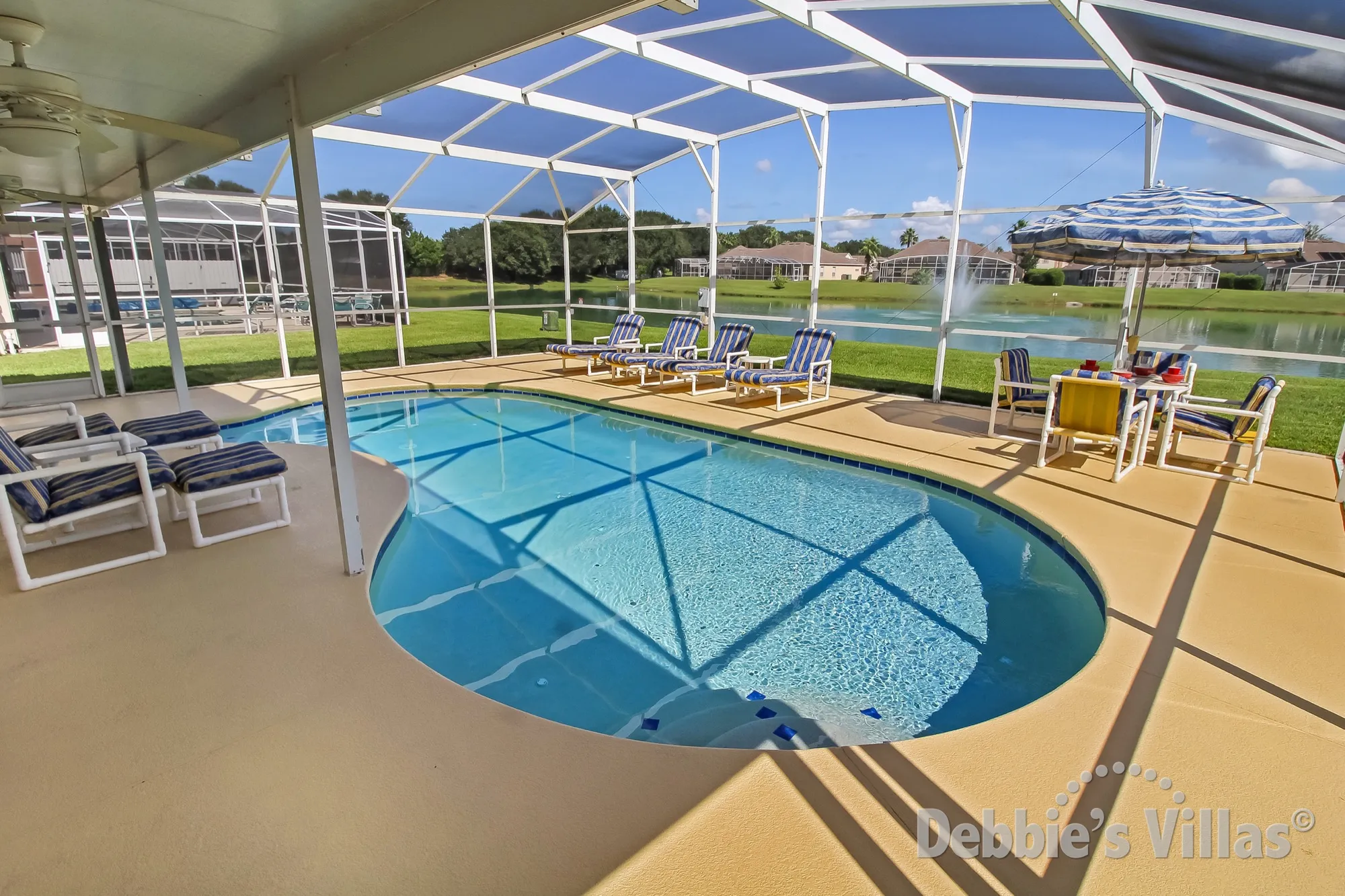 Hampton Lakes villa with a large pool deck and lake view