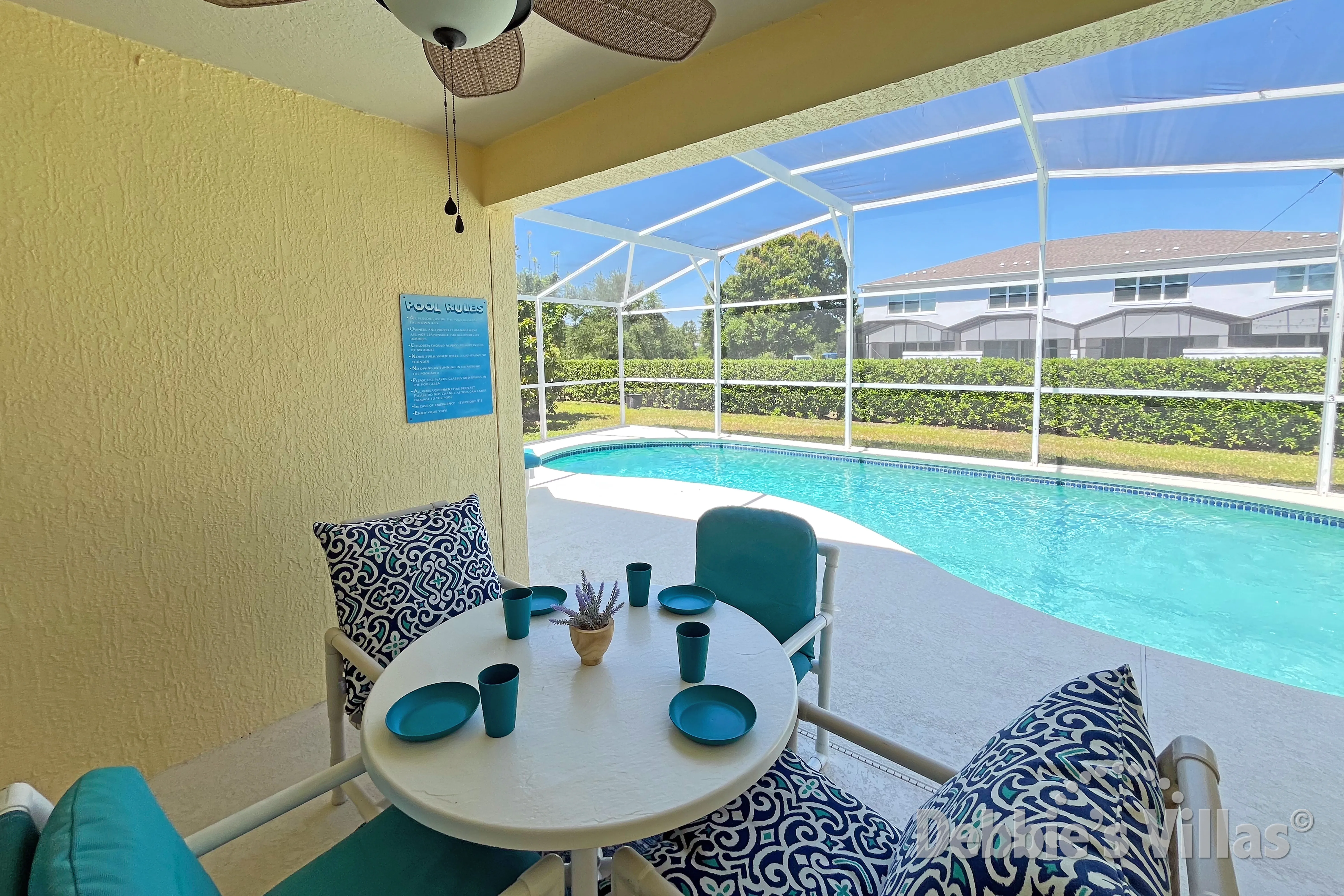 Enjoy a chilled drink and snack at the covered poolside table