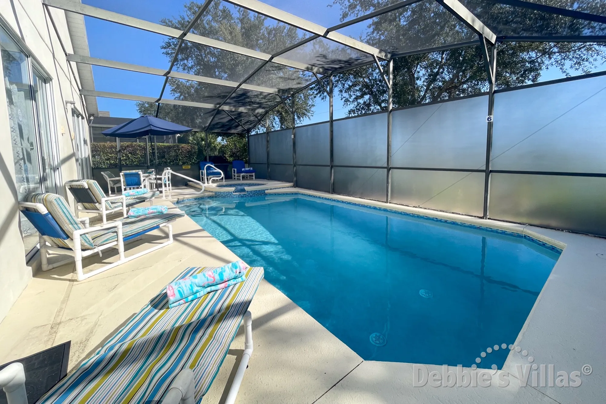 Sunny pool and spa deck at this Clermont vacation villa