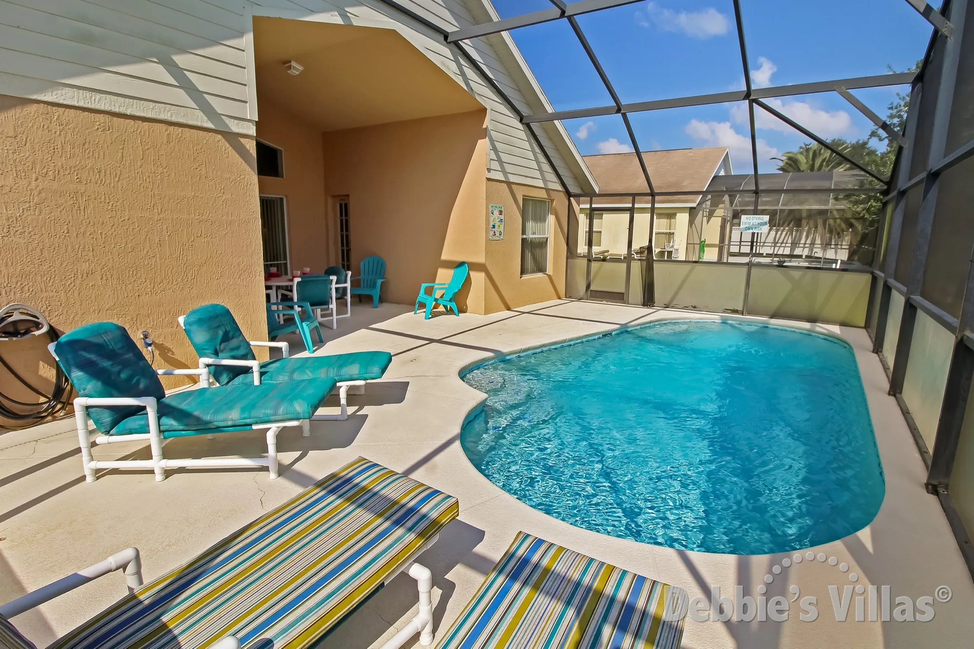 Orange Tree villa with a sunny pool deck and privacy screens