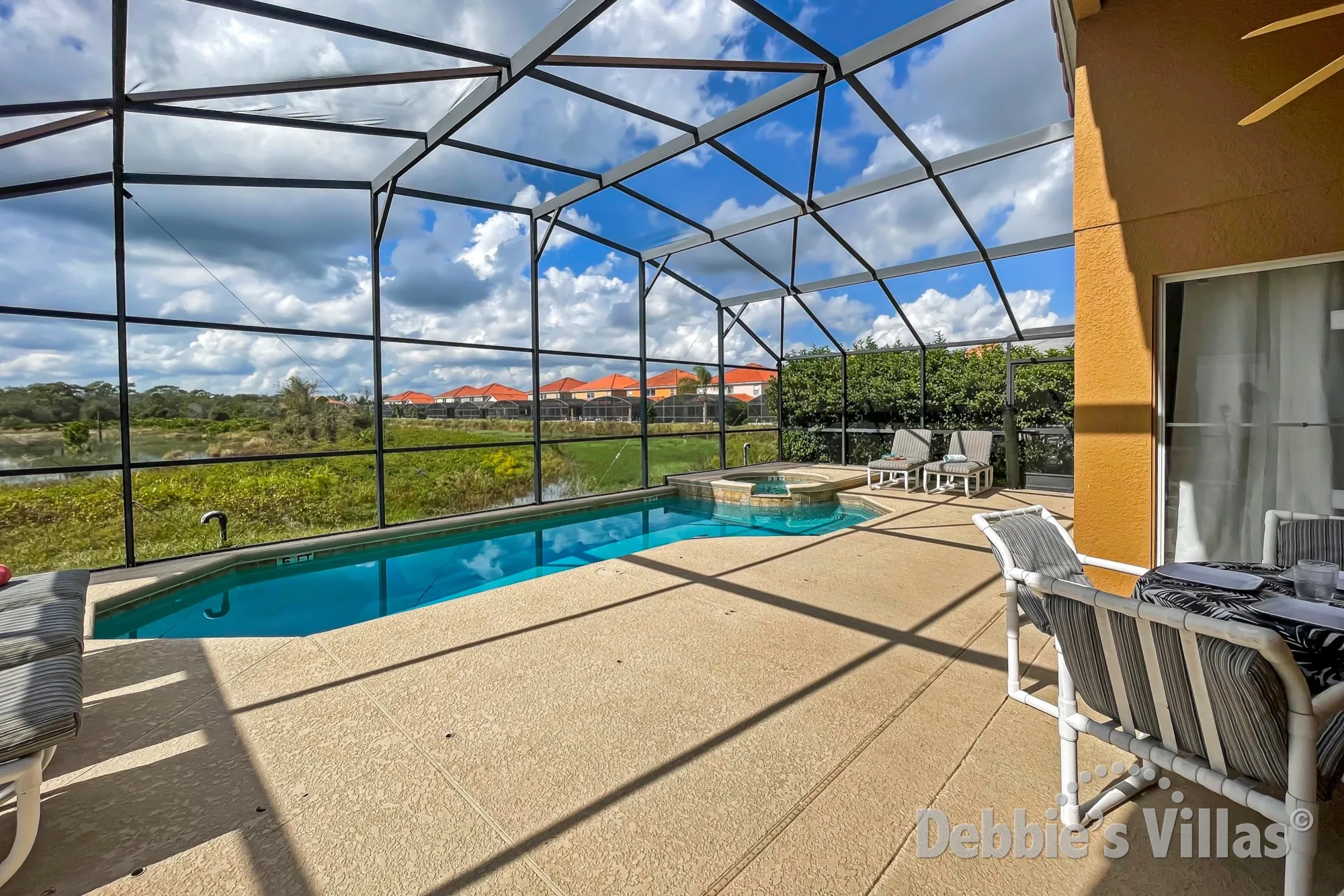 West-facing private pool and spa with a lake view at this villa on the gated resort of Aviana