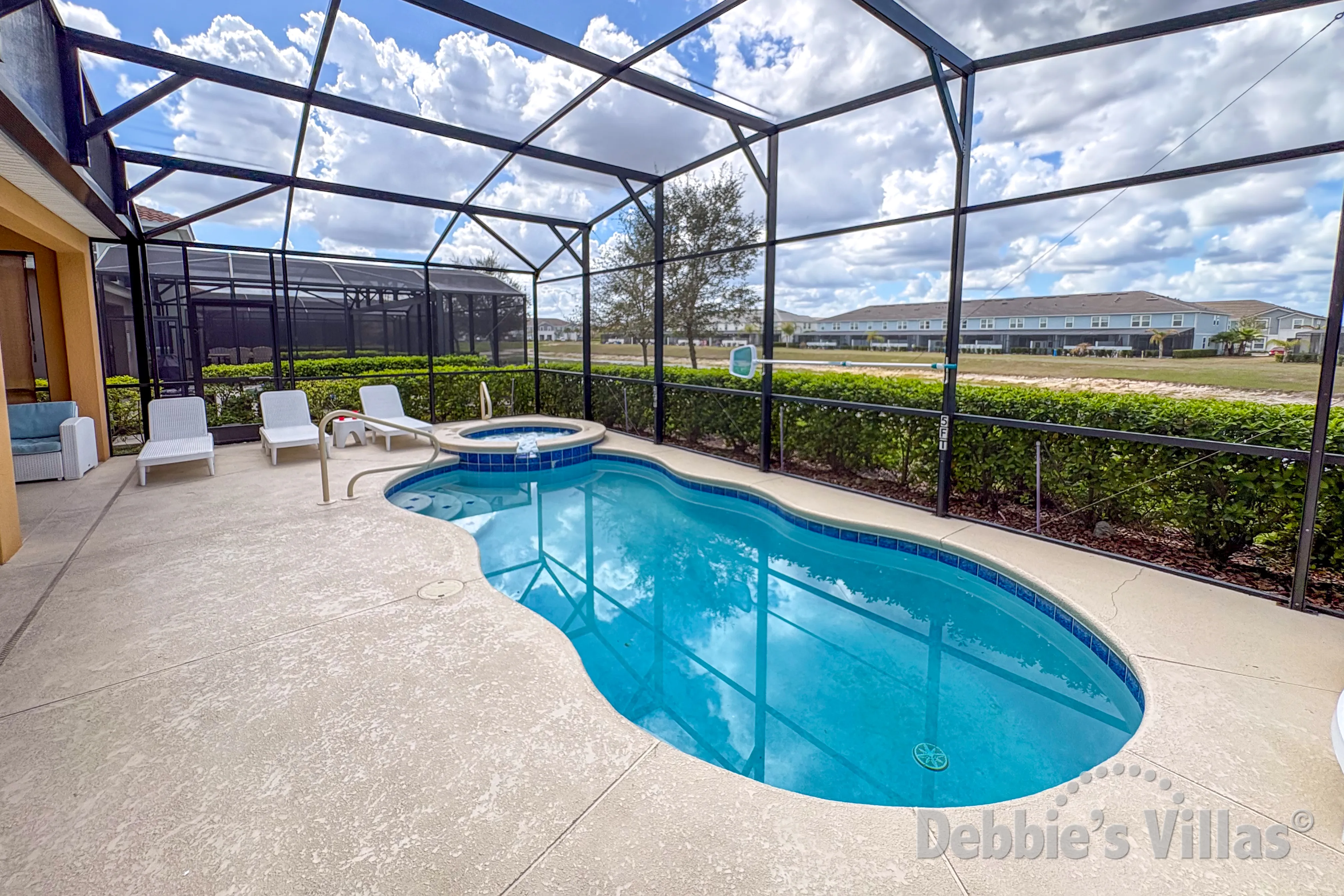 West-facing pool and spa at this vacation villa on Solterra in Davenport 