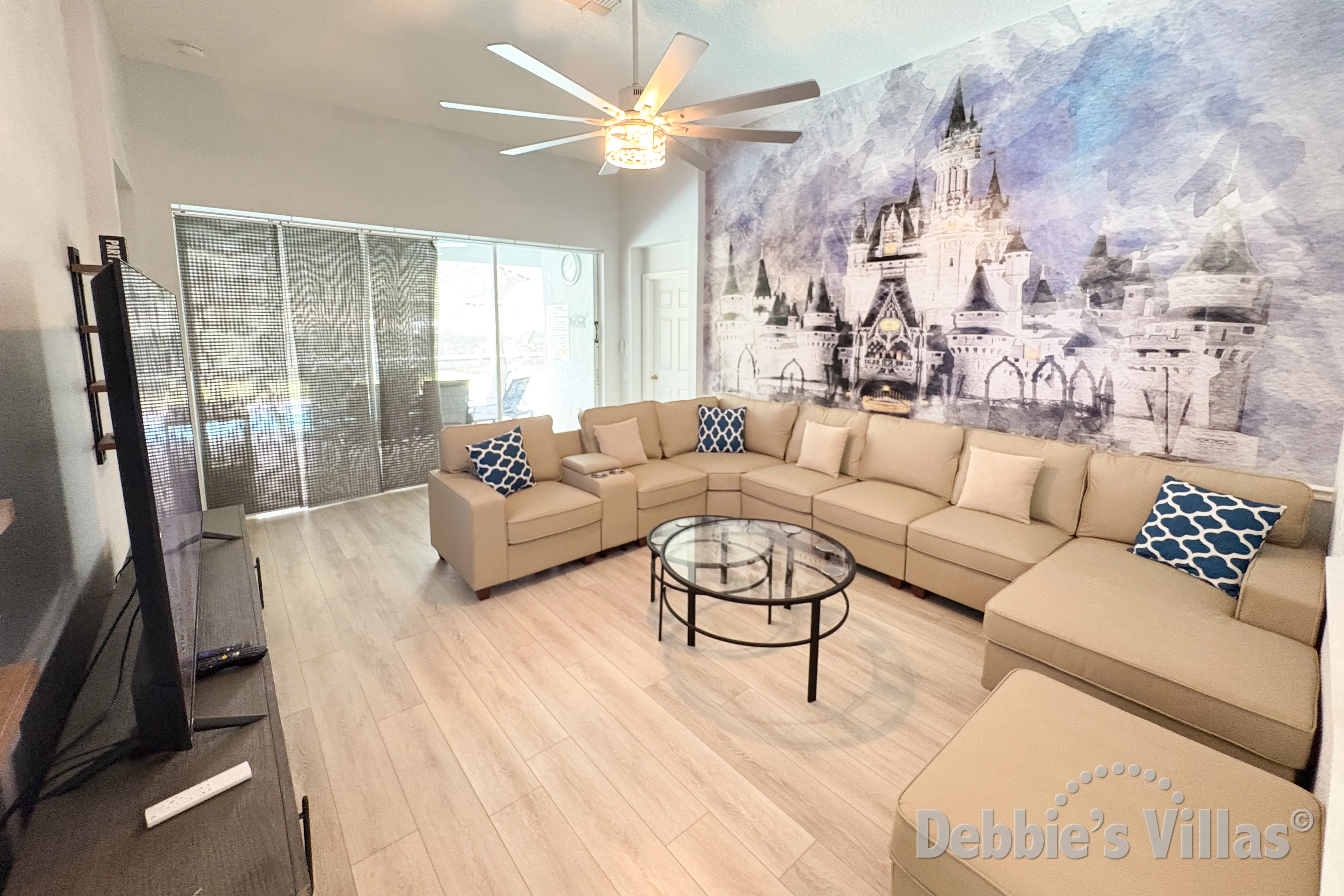 Plenty of seating and lots of natural light in the family lounge in this Kissimmee vacation villa 