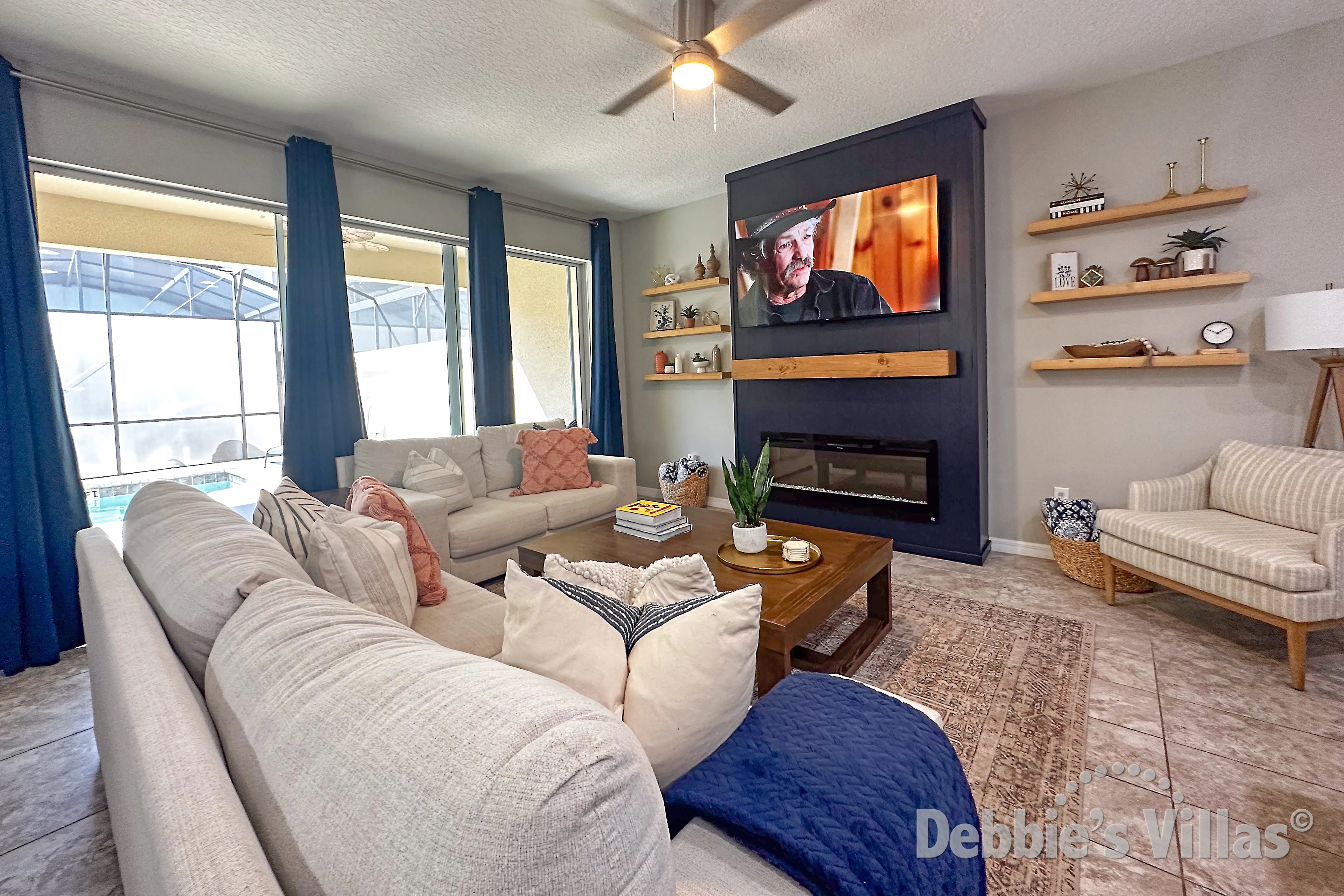 Family lounge with lots of natural light and doors to pool deck in this Kissimmee vacation home
