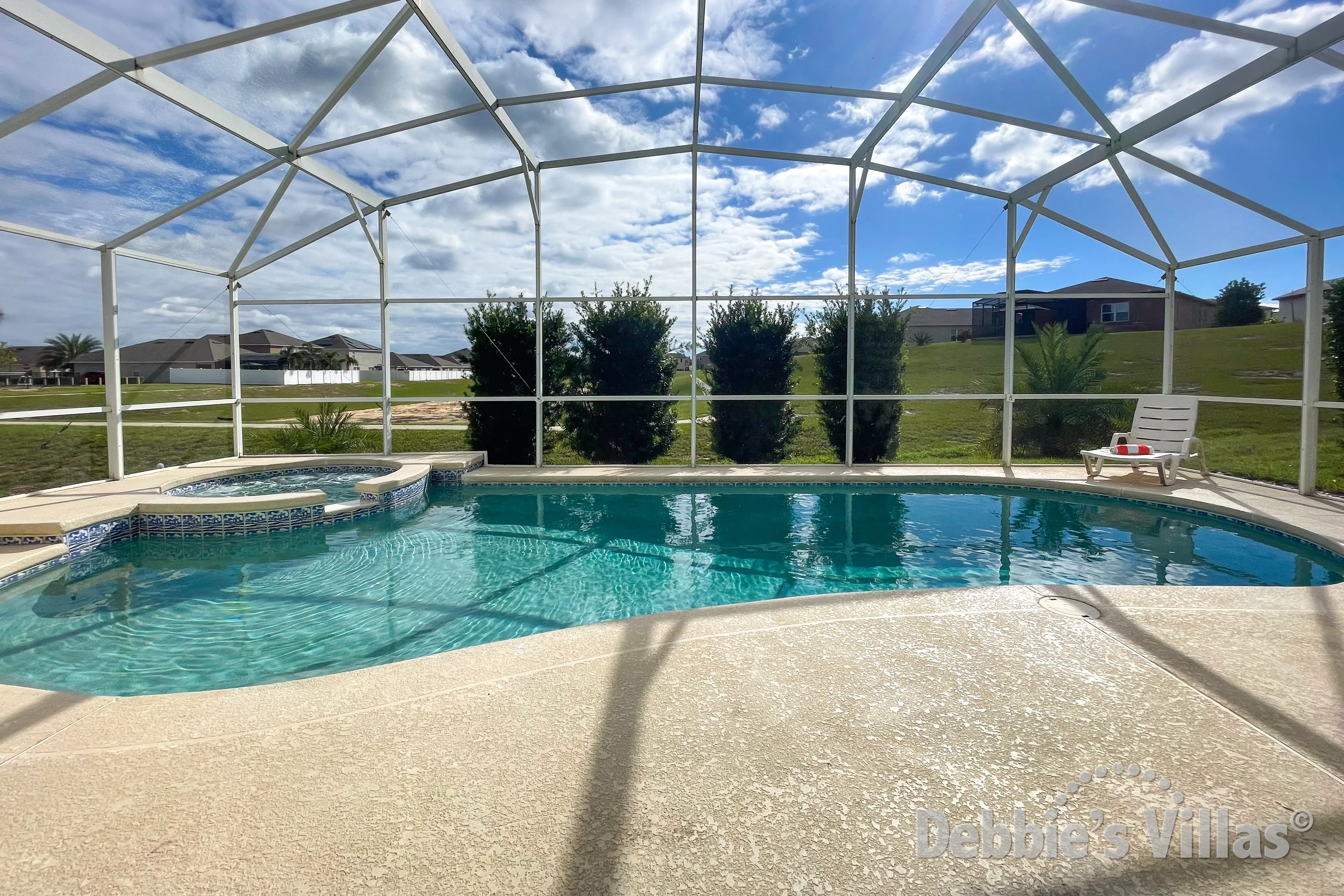 Sun-drenched pool and spa deck at this Davenport vacation villa