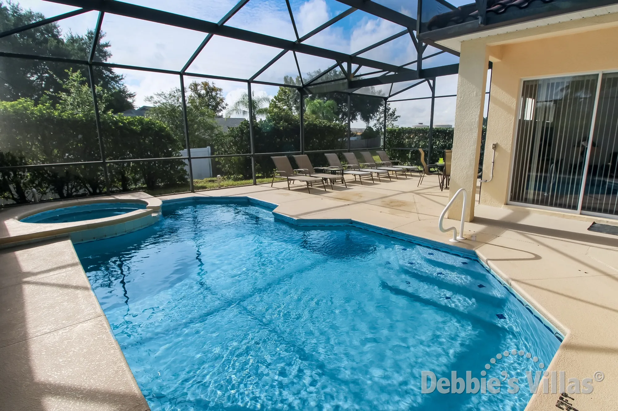 Large southeast-facing pool and spa deck at this Tuscan Hills villa in Davenport