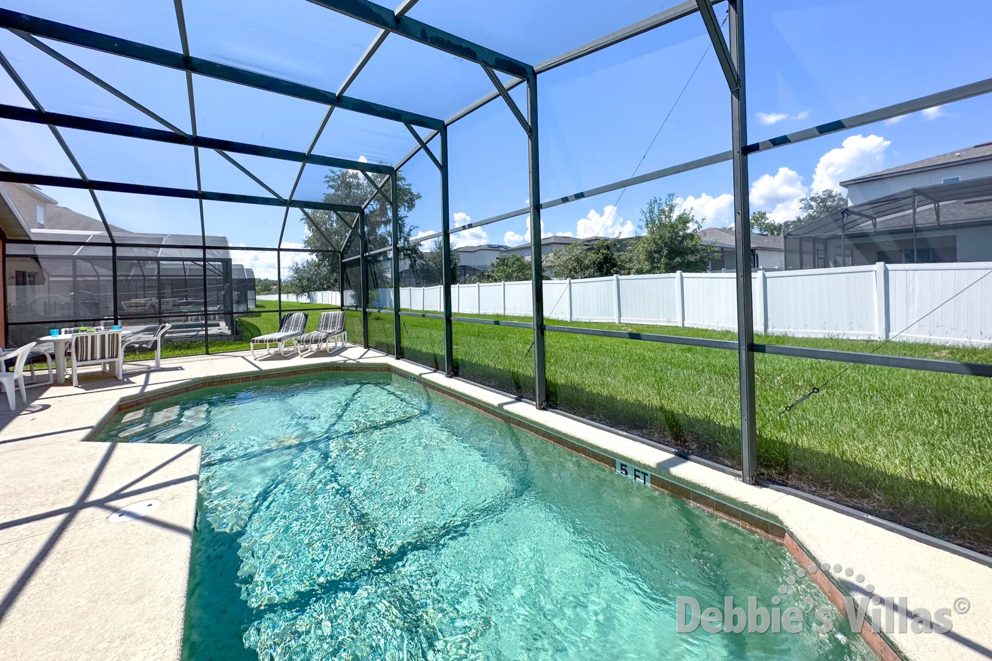 Sunny west-facing pool deck at this Kissimmee vacation villa