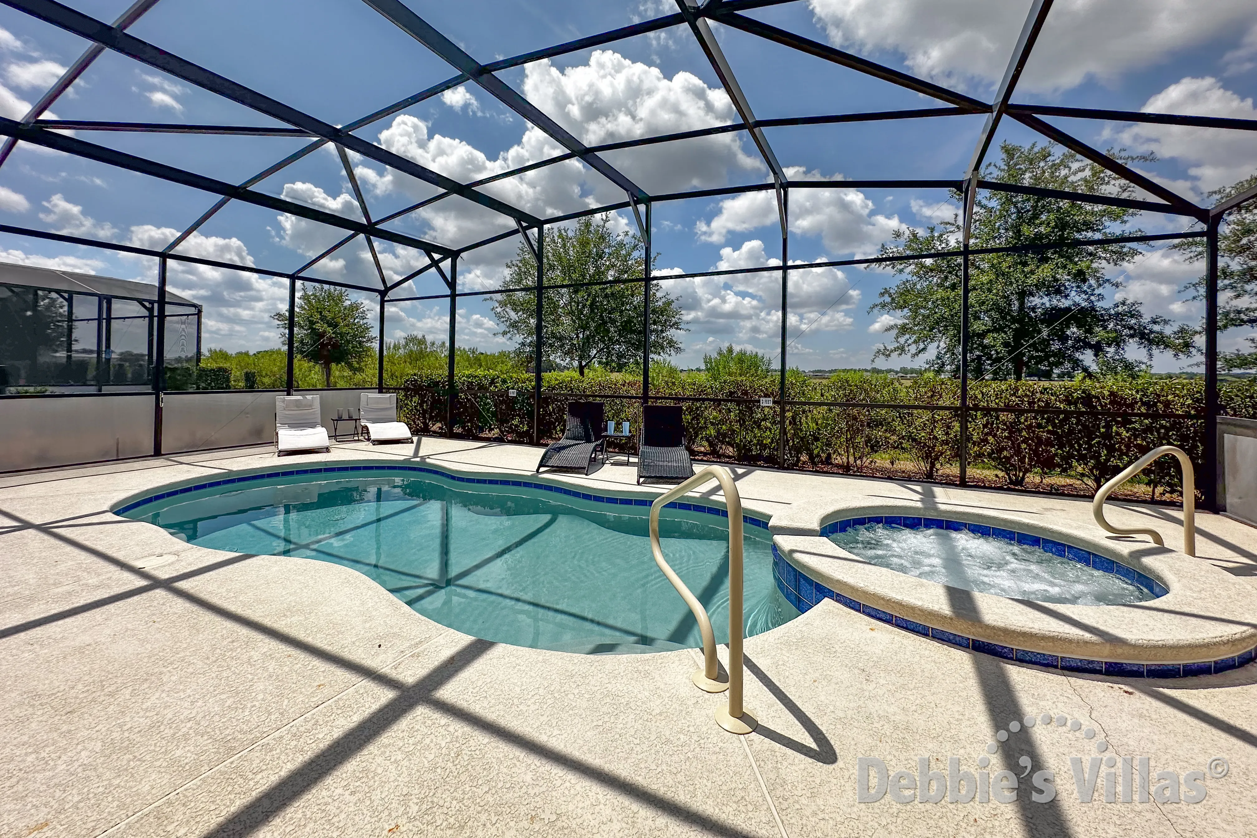 South-facing pool and spa at this vacation villa on Solterra in Davenport