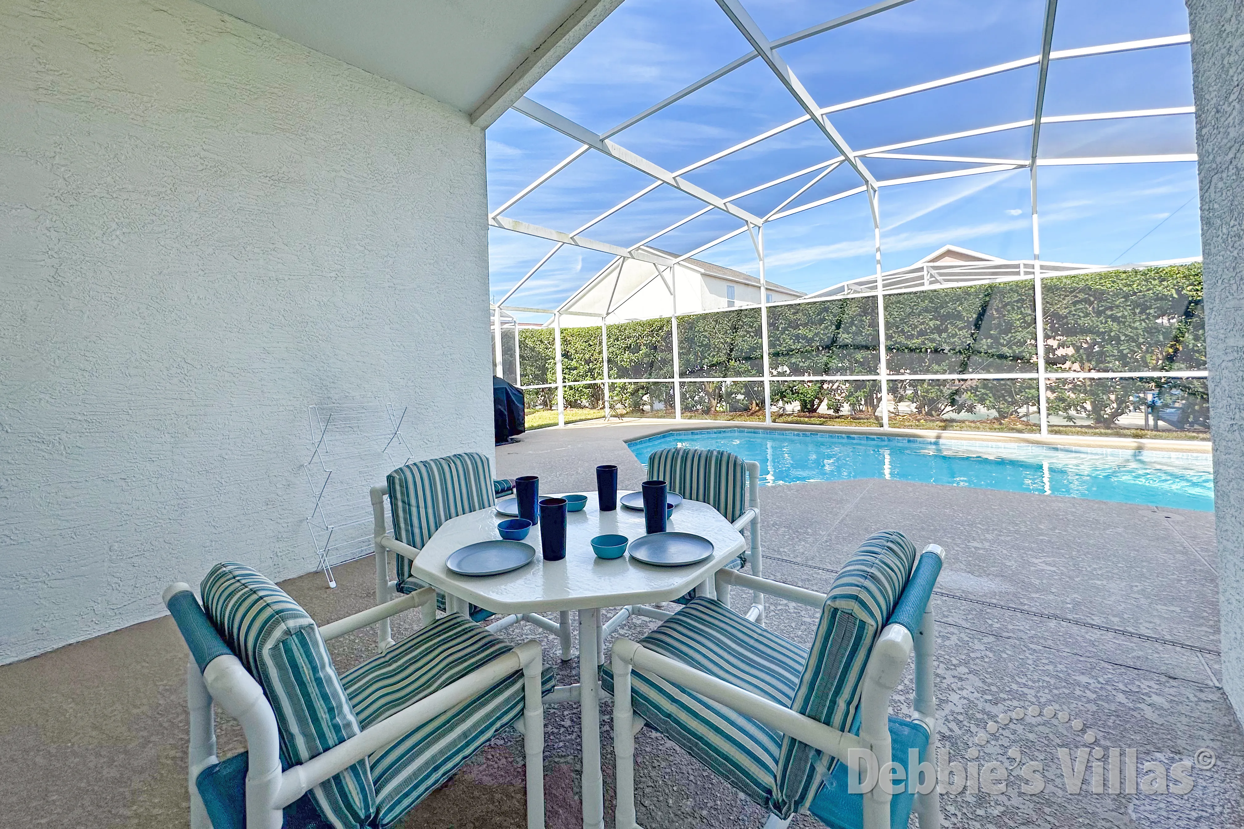 Dine poolside under the covered area at this Davenport vacation villa