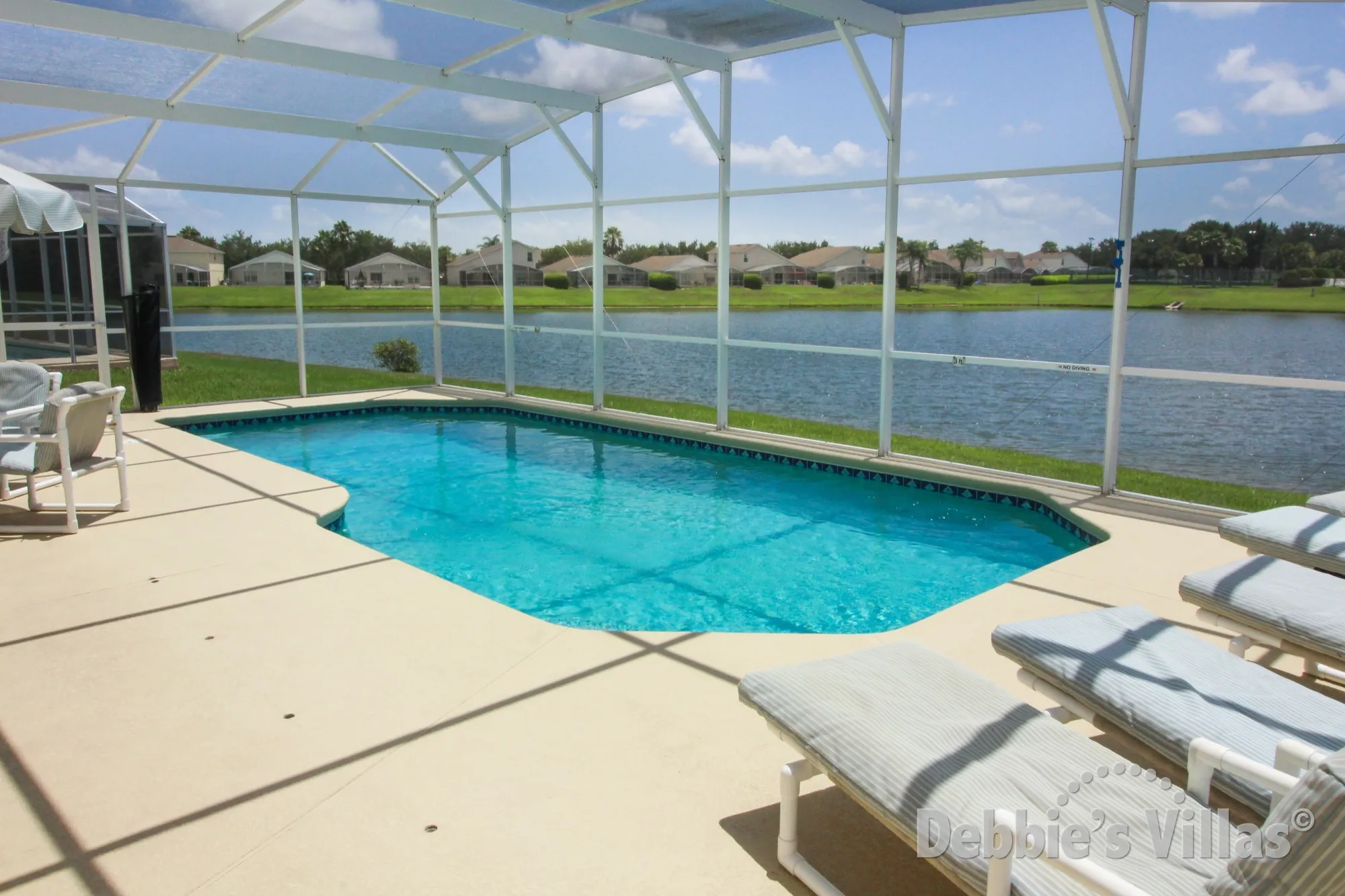 South-facing pool deck with lake views on the Davenport community of Hampton Lakes