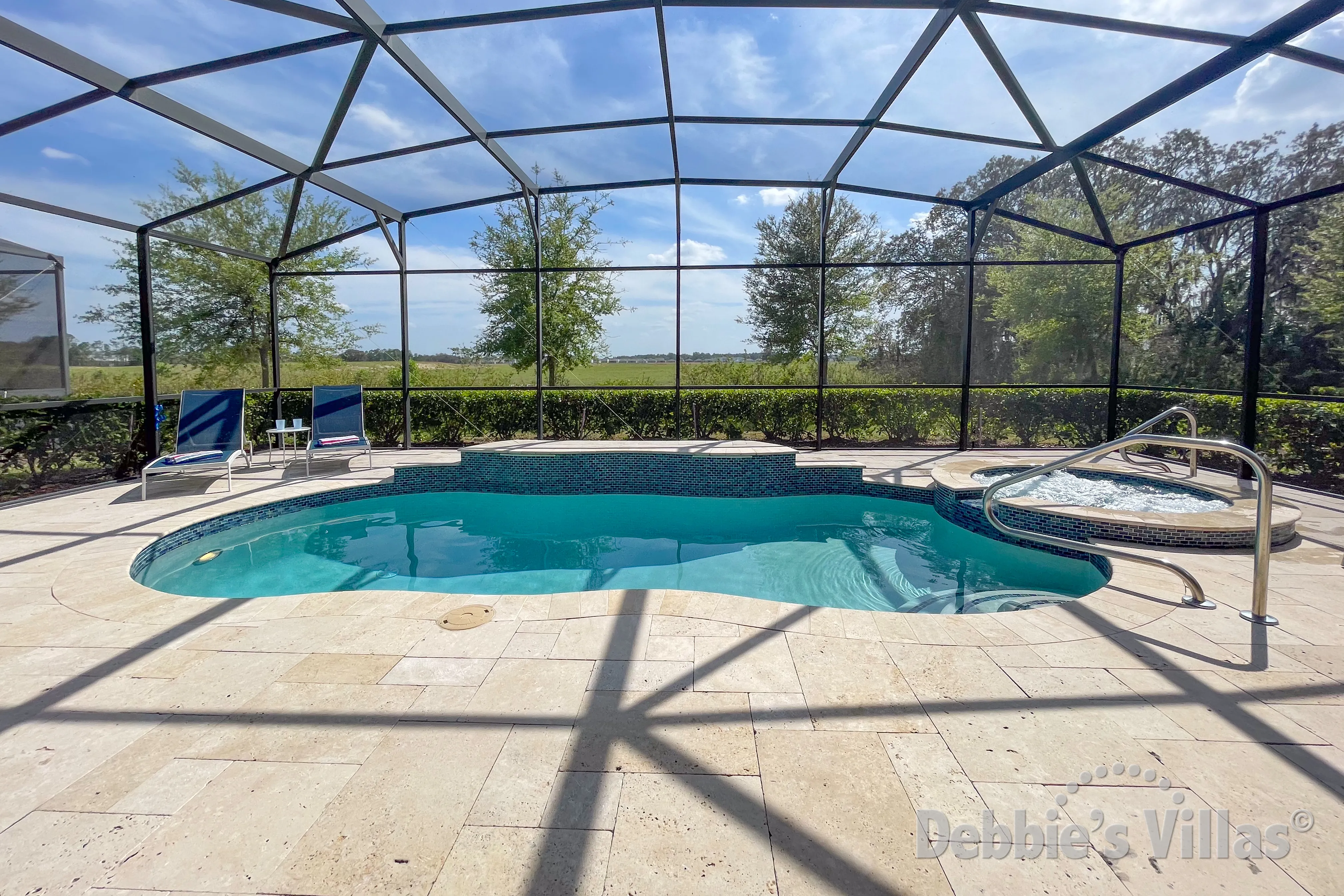 South-facing pool and spa at this vacation villa on Solterra in Davenport