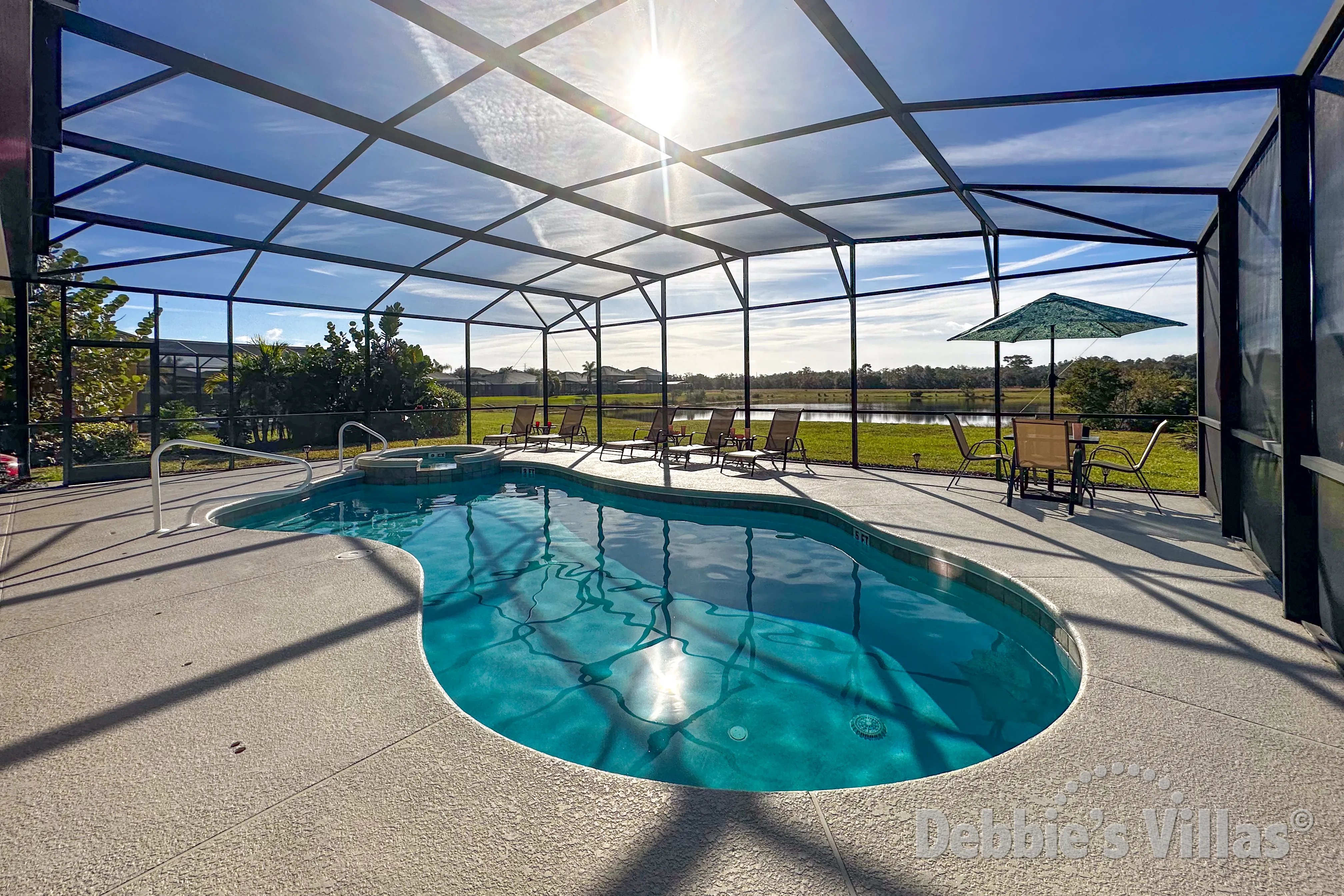 Sun-drenched south-facing pool deck with gorgeous lake view at this Watersong vacation villa