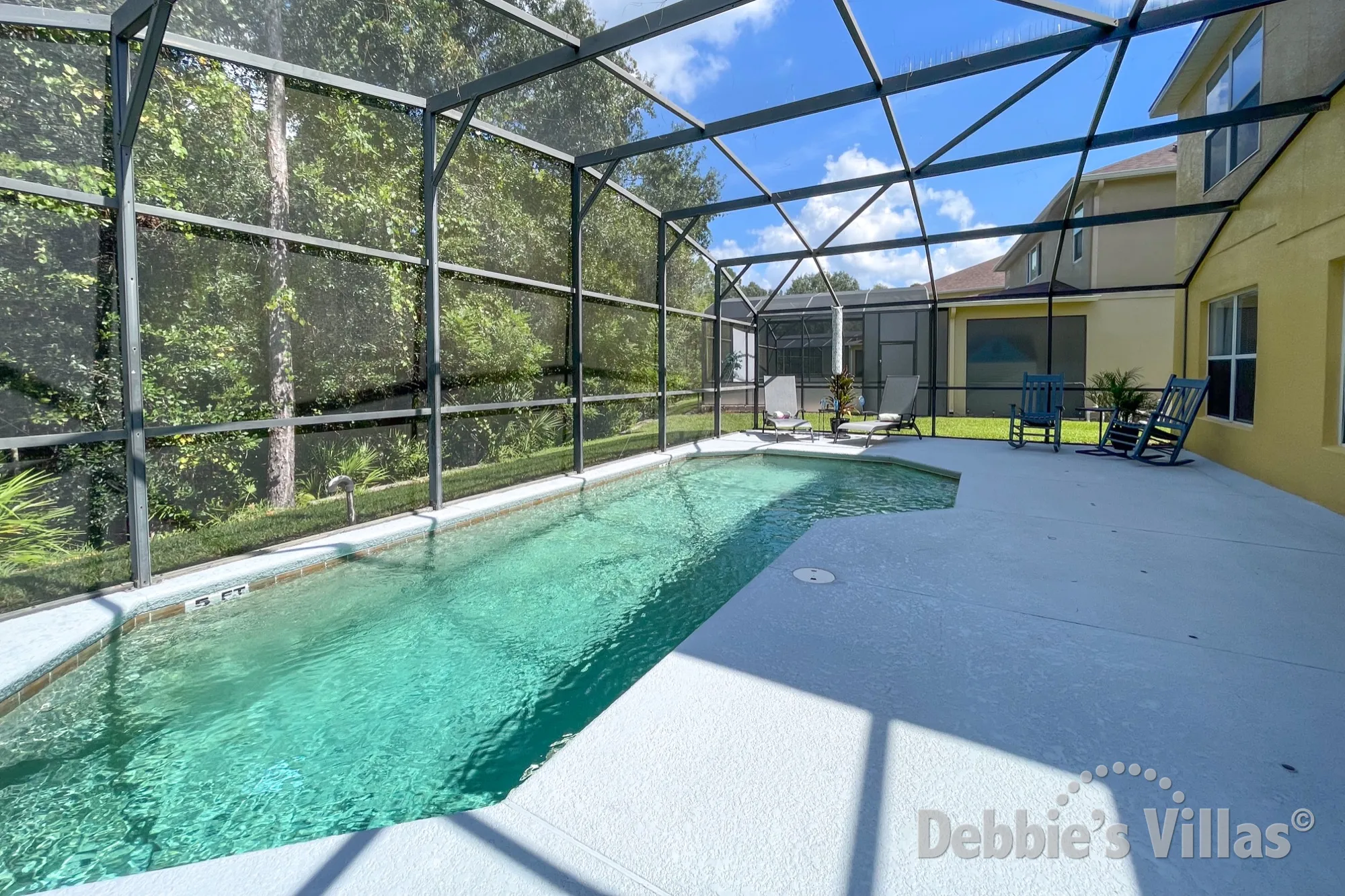 Sunny south-facing pool deck with conservation view at this Terra Verde vacation villa