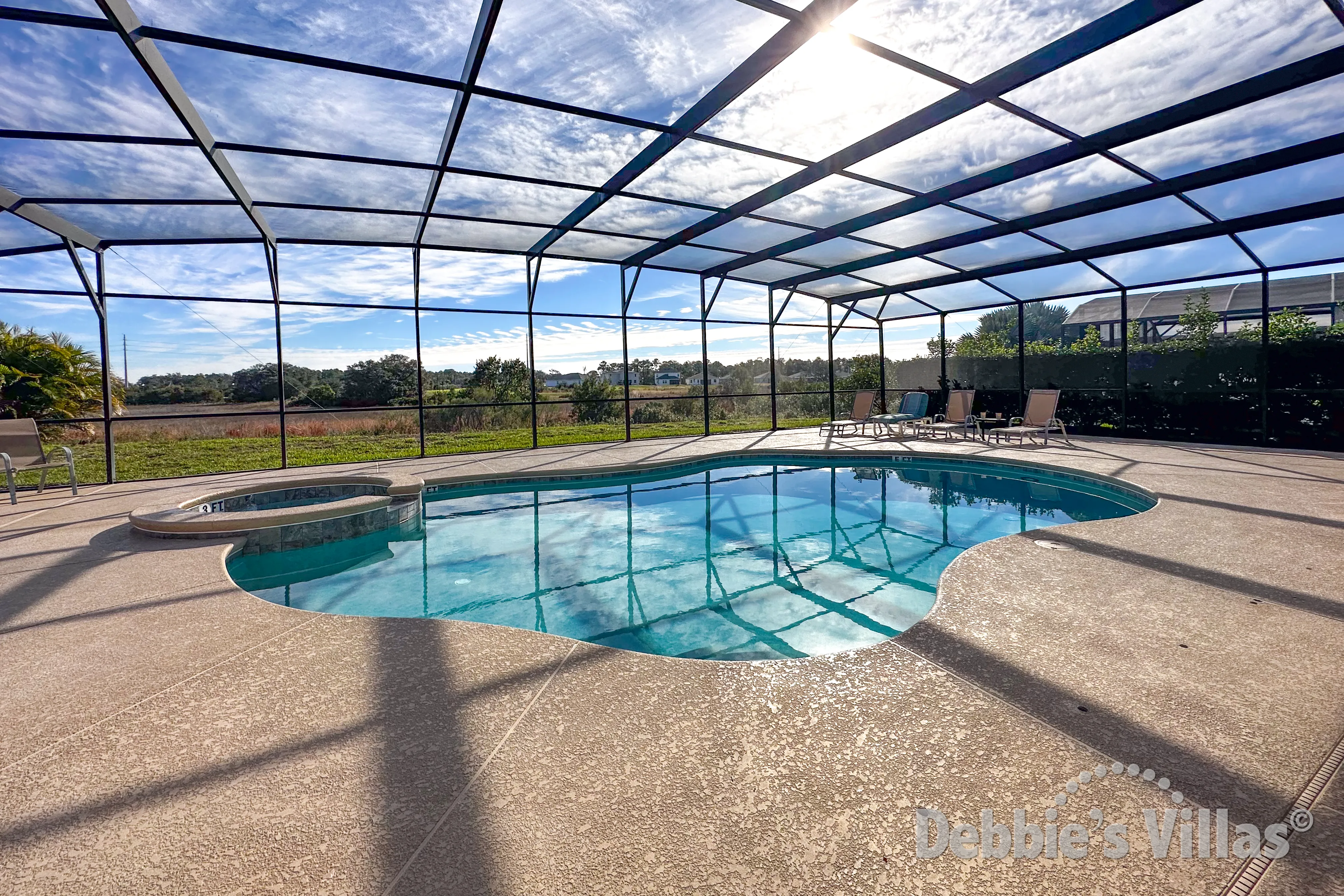 Stunning extended pool and spa deck with scenic view from this Watersong vacation villa