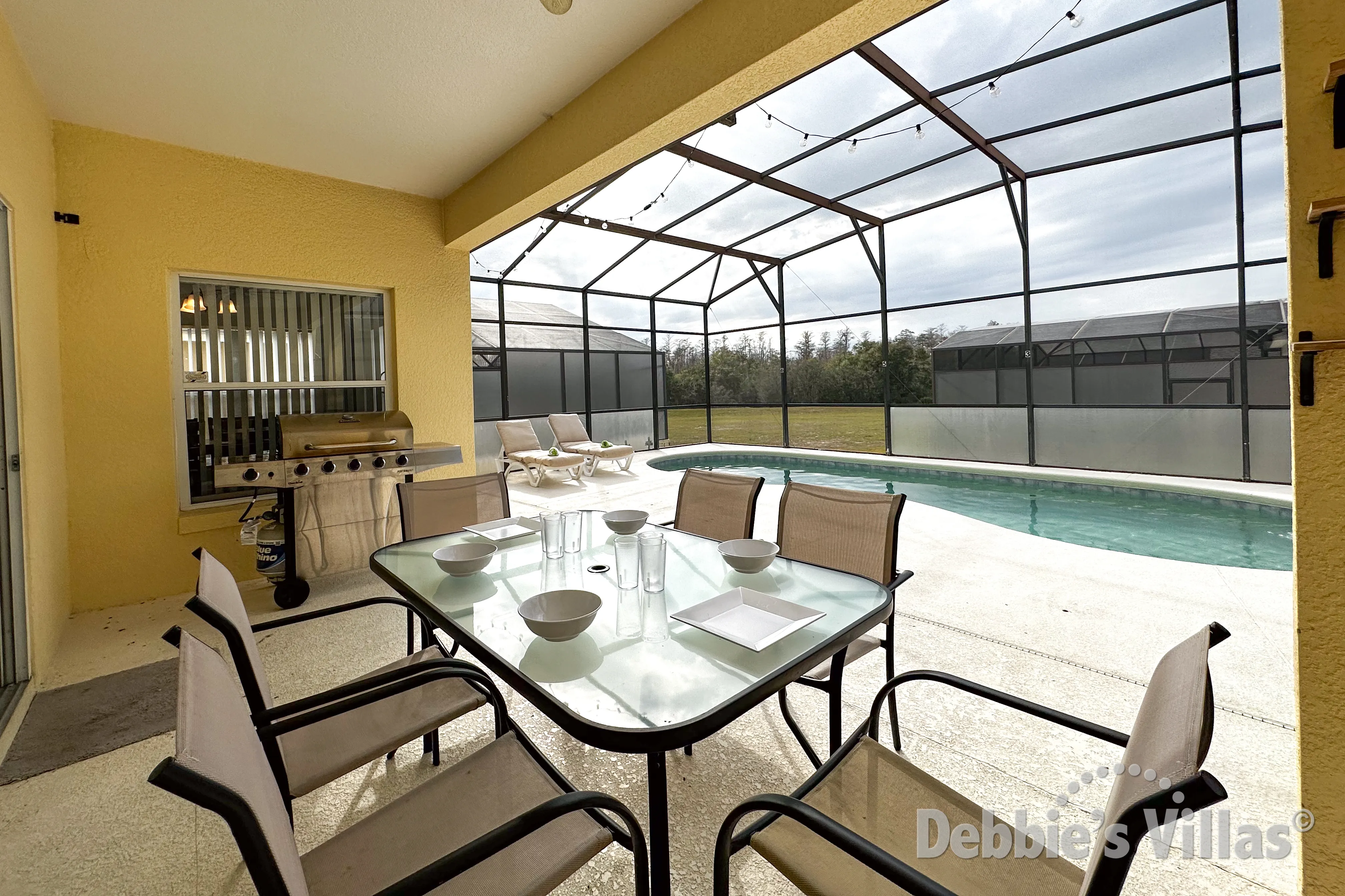 Enjoy dining alfresco by the west-facing pool and spa at this Kissimmee vacation villa