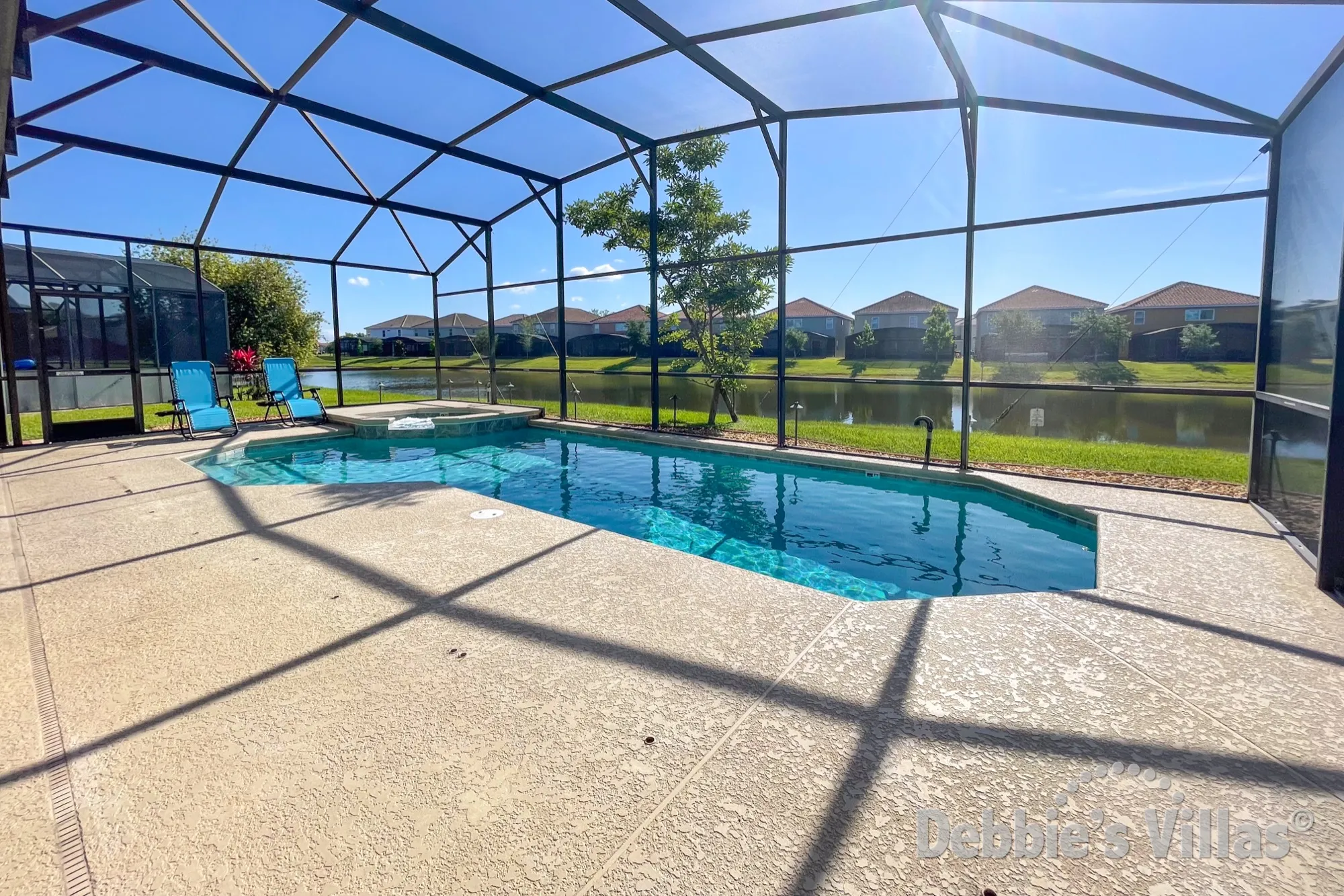 Stunning lake view from the sun-drenched pool deck at this Kissimmee vacation villa