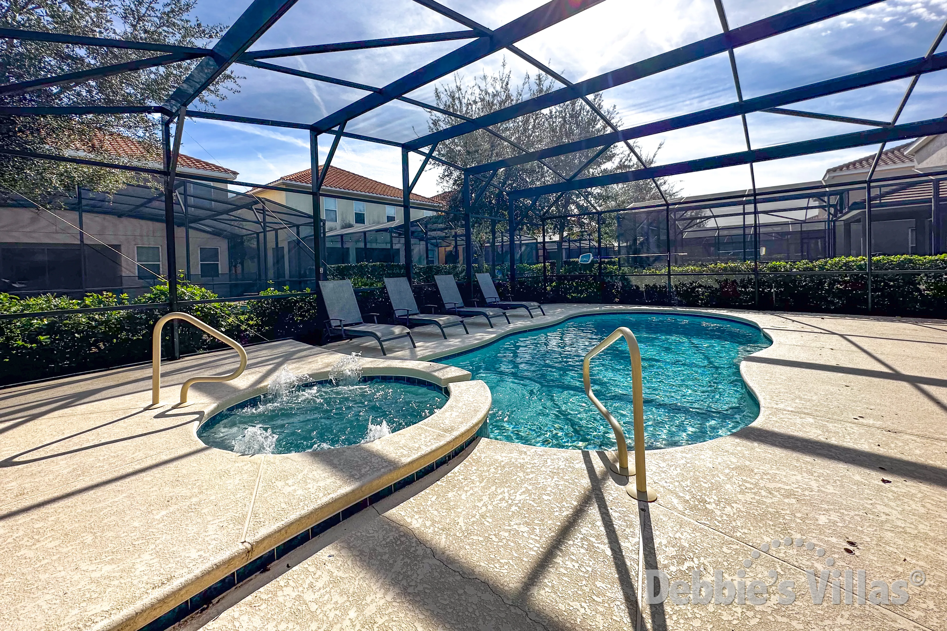 Sun-drenched extended pool and spa deck at this Solterra vacation villa