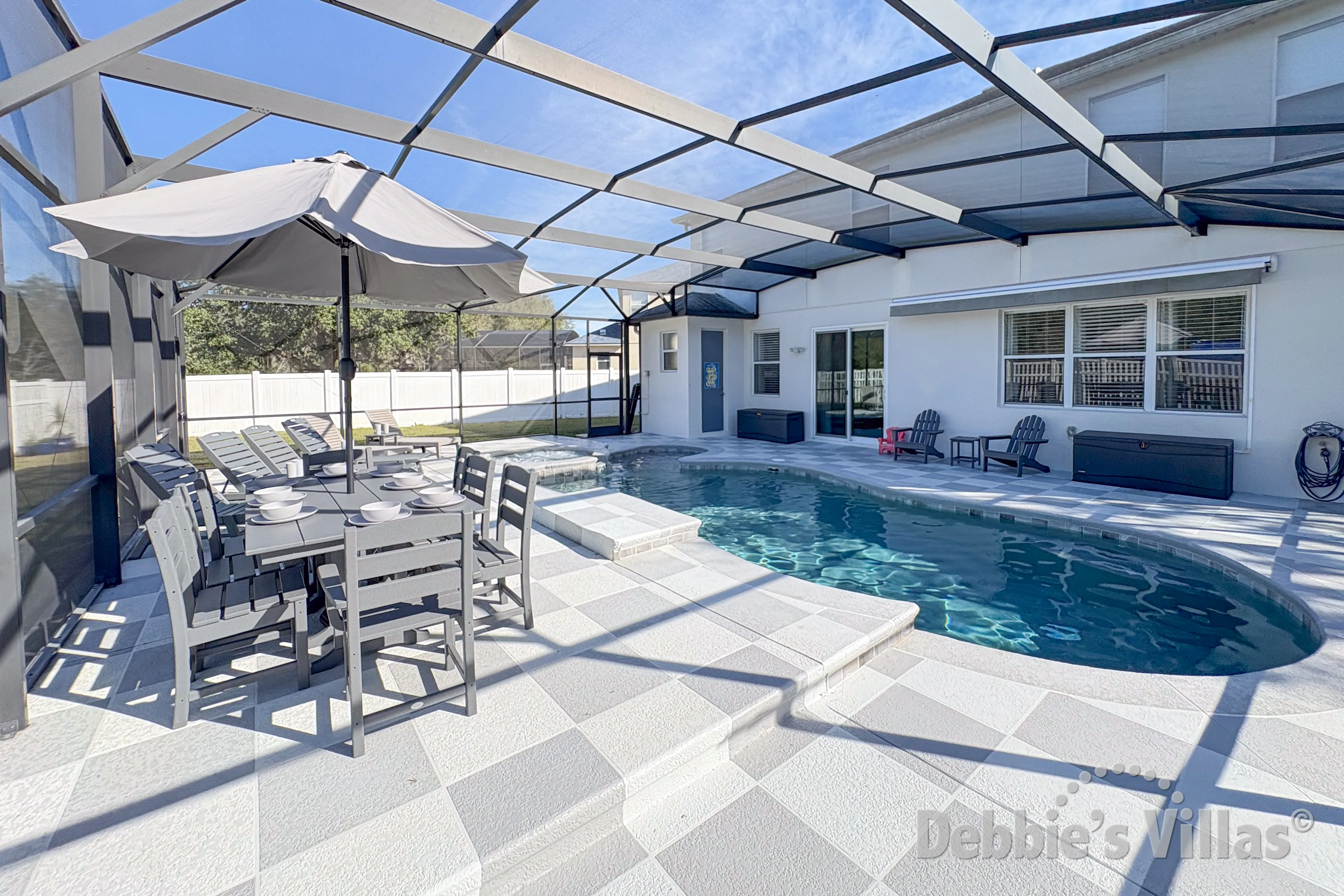 Have a meal and a chilled drink at the poolside dining table at this Davenport vacation villa 