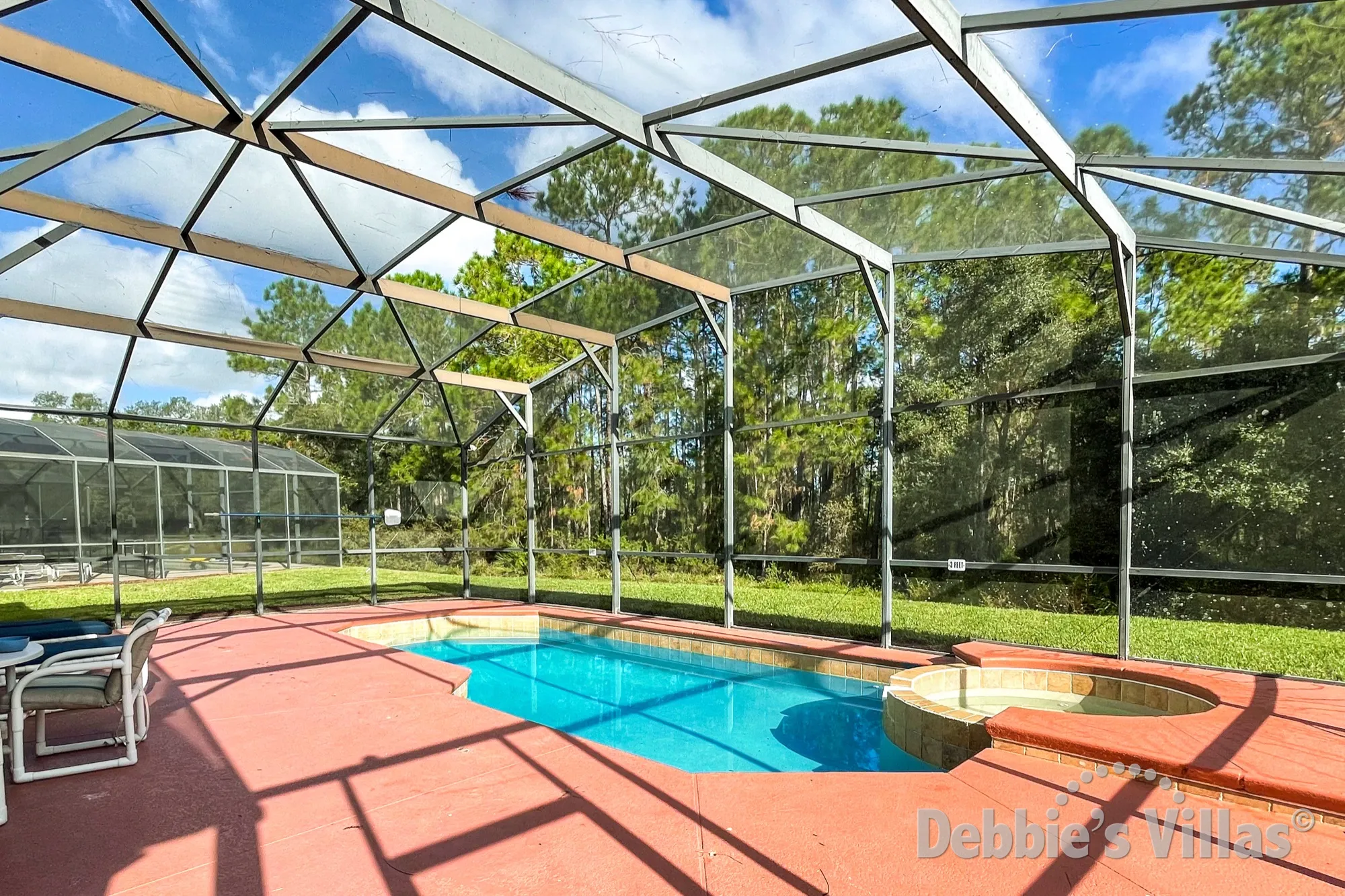 Large private pool and spa deck with a scenic view from this Watersong villa in Davenport